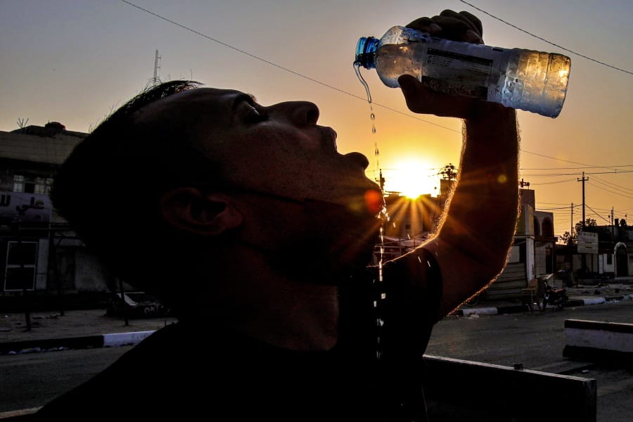 Laith Jabbar, a gas station worker, cools off July 27 in Basra, Iraq.