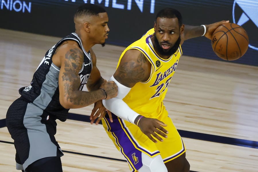 Sacramento Kings&#039; DaQuan Jeffries, left, defends against Los Angeles Lakers&#039; LeBron James during the second quarter of an NBA basketball game Thursday, Aug. 13, 2020, in Lake Buena Vista, Fla. (Kevin C. Cox/Pool Photo via AP) (Kevin C.
