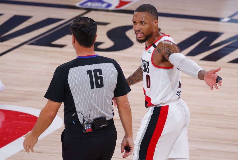 Portland Trail Blazers&#039; Damian Lillard (0) argues with referee David Guthrie (16) during the first quarter of Game 4 of an NBA basketball first-round playoff series against the  Los Angeles Lakers, Monday, Aug. 24, 2020, in Lake Buena Vista, Fla. (Kevin C.