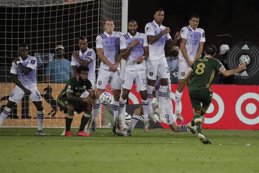 Orlando players block a free kick by Portland Timbers midfielder Diego Valeri (8), during the second half of an MLS soccer match, Tuesday, Aug. 11, 2020, in Kissimmee, Fla.