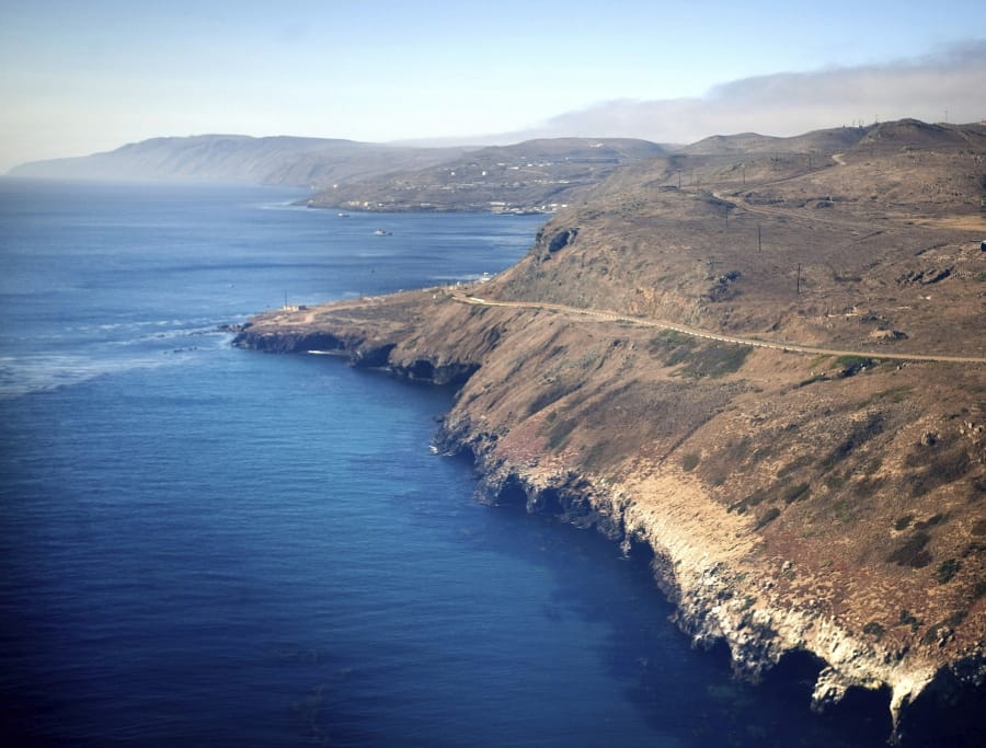 In this July 16, 2013, photo is an aerial view of the coast and Pacific Ocean taken flying in to San Clemente Island, in San Diego. A military seafaring assault vehicle that sank off the coast of Southern California with Marines and one Navy corpsman on board is under hundreds feet of water, making it impossible for divers to reach the landing craft and complicating rescue efforts for the missing troops, officials said Friday, July 31, 2020.