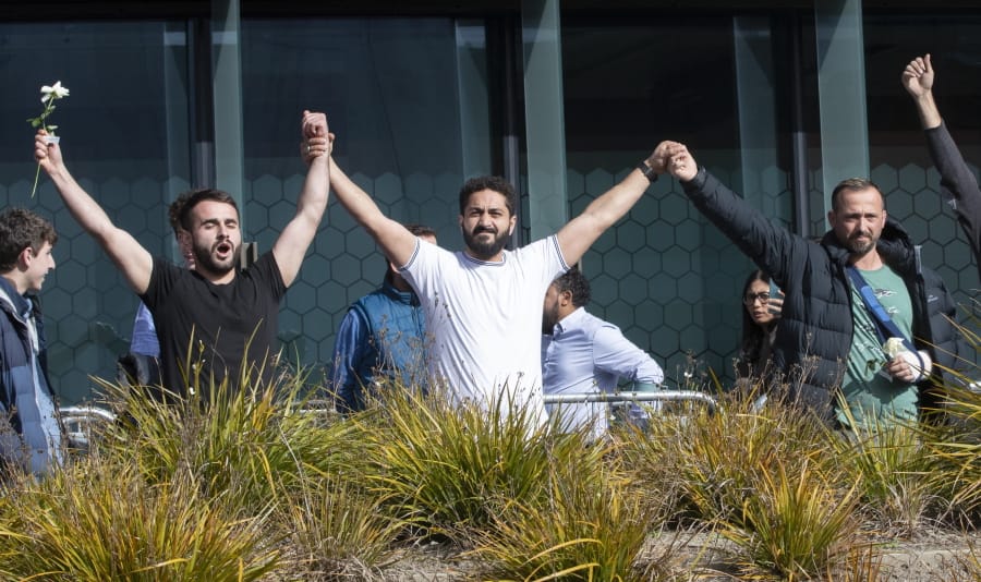 Mosque shooting survivors from left, Mustafa Boztas, Wassail Daragmih and Temel Atacocugu celebrate as they leave the Christchurch High Court after the sentencing hearing for Australian Brenton Harrison Tarrant, in Christchurch, New Zealand, Thursday, Aug. 27, 2020. Tarrant, a white supremacist who killed 51 worshippers at two New Zealand mosques in March 2019 was sentenced to life in prison without the possibility of parole.