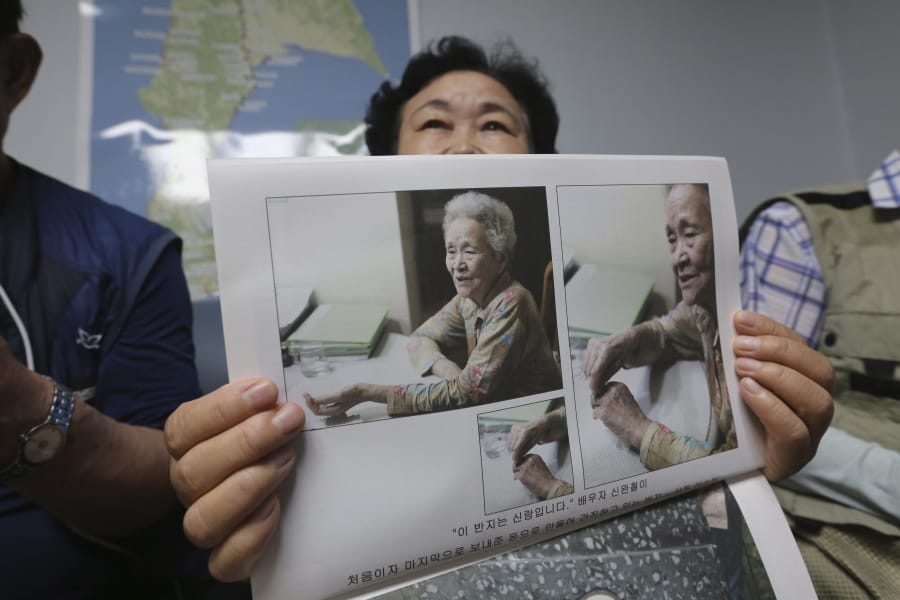 South Korean Shin Yun-sun shows photos of her 92-year-old mother, Baek Bong-rye, during an interview at her house in Seoul, South Korea Wednesday, July 29, 2020. Shin, 75, has spent decades pestering government officials, digging into records and searching burial grounds on Russia&#039;s desolate Sakhalin island, desperately searching for traces of a father she never met. Shin wants to bring back the remains of her presumably dead father for her ailing mother.