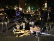 A man is being treated after being shot Saturday, Aug. 29, 2020, in Portland, Ore. Fights broke out in downtown Portland Saturday night as a large caravan of supporters of President Donald Trump drove through the city, clashing with counter-protesters.