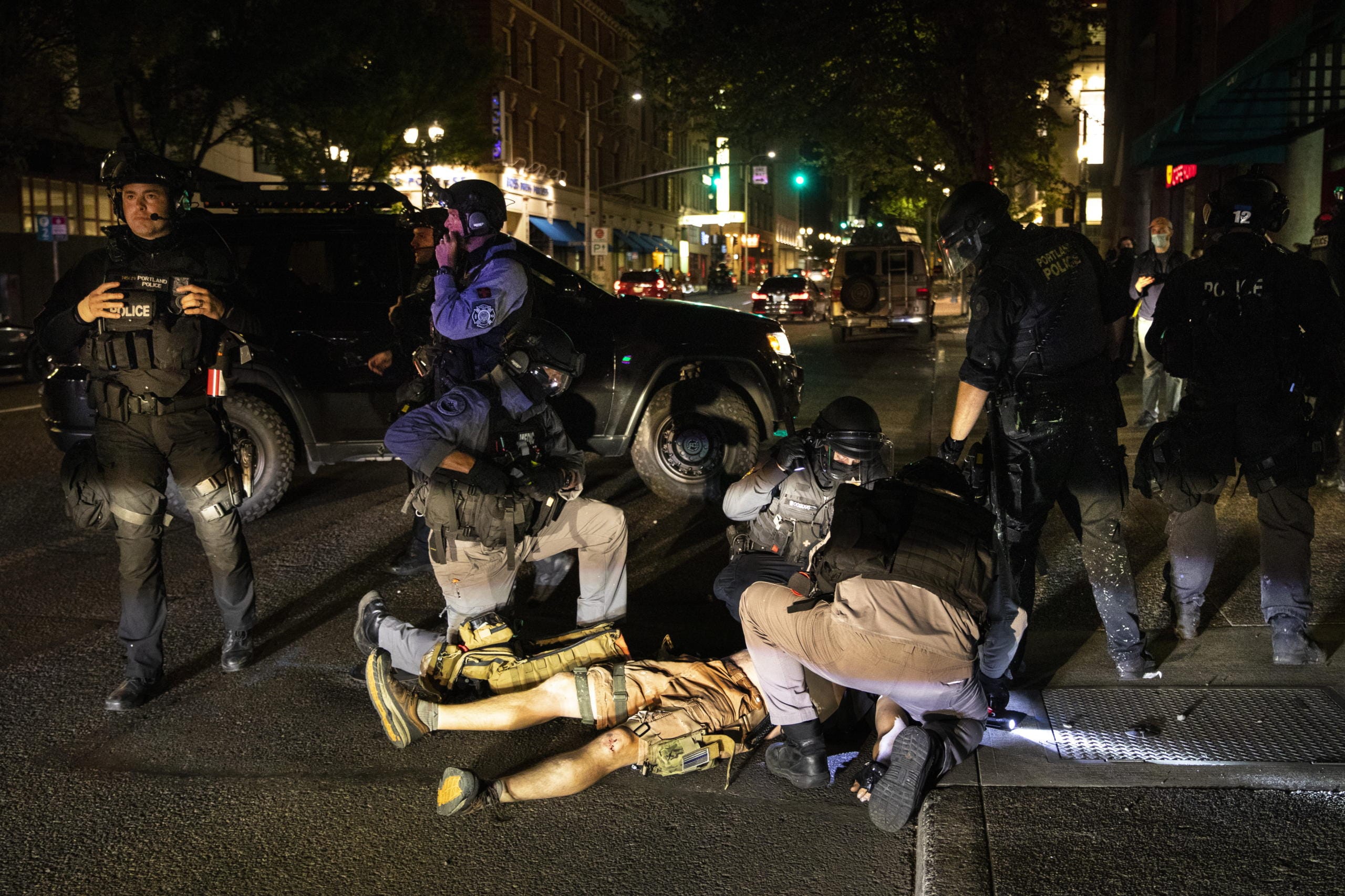 A man is being treated after being shot Saturday, Aug. 29, 2020, in Portland, Ore. Fights broke out in downtown Portland Saturday night as a large caravan of supporters of President Donald Trump drove through the city, clashing with counter-protesters.