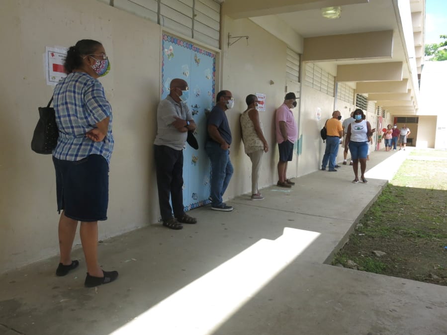 Voters wait to cast their ballots in Loiza, Puerto Rico, Sunday, Aug. 16, 2020. Thousands of Puerto Ricans on Sunday got a second chance to vote for the first time, a week after delayed and missing ballots marred the original primaries in a blow to the U.S. territory&#039;s democracy.