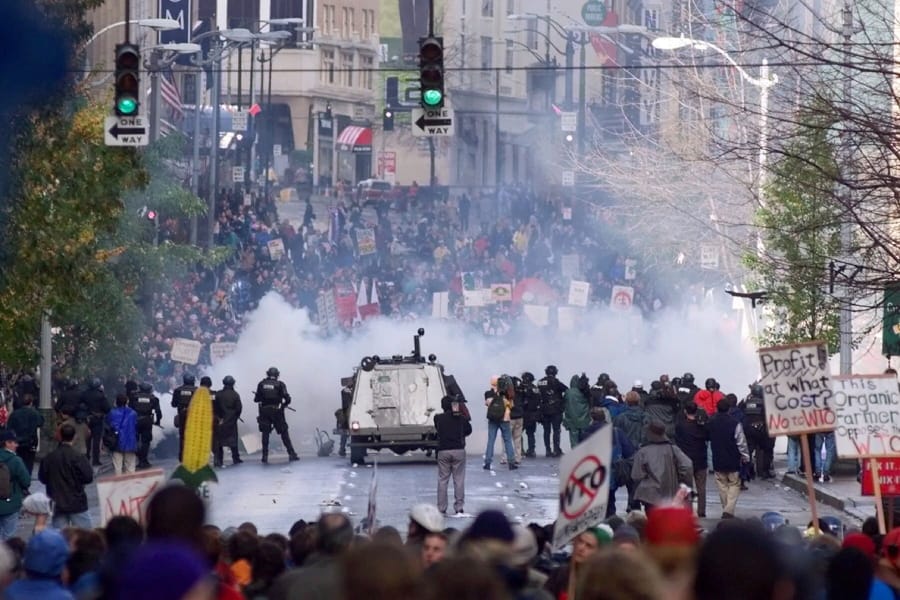FILE - In this Nov. 30, 1999, file photo, Seattle police use tear gas to push back World Trade Organization protesters in downtown Seattle. The Associated Press found that there is no government oversight of the manufacture and use of tear gas. Instead, the industry is left to regulate itself.