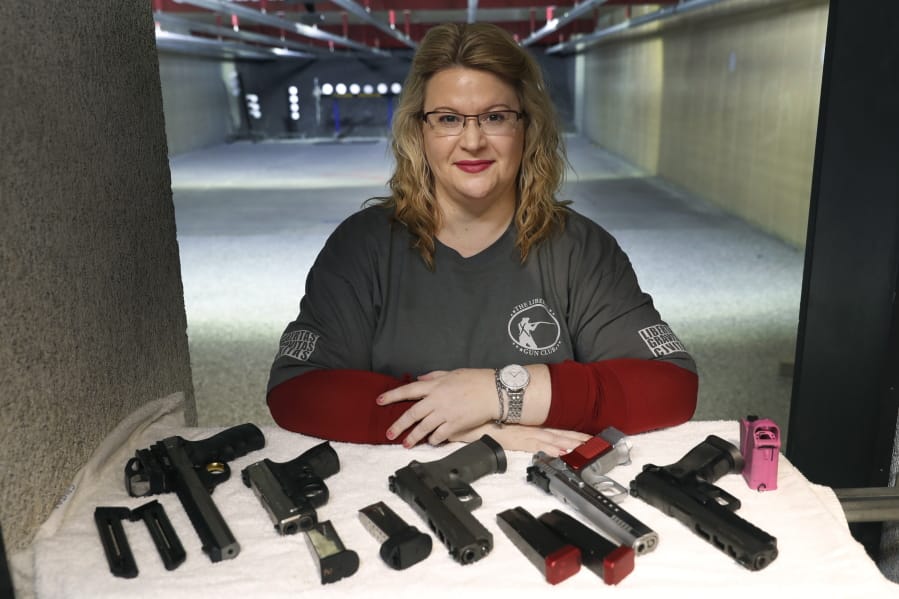 Kat Ellsworth displays five of the seven guns she owns Feb. 5 at the Caliber Tactical Gun Range in Waukegan, Ill.