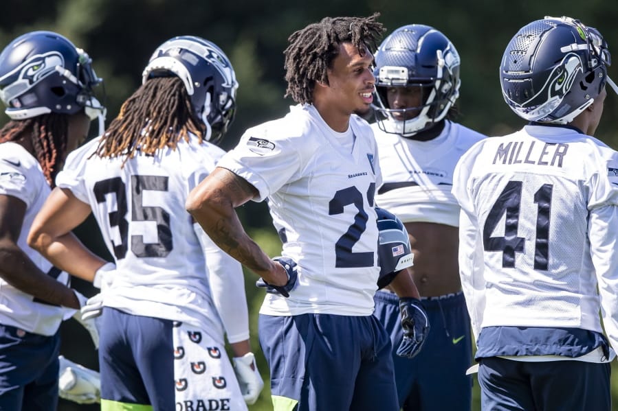 Seahawks cornerback Quinton Dunbar, center, stands at training camp in Renton. Though not revealing specifics, Dunbar spoke vaguely about an offseason arrest in Florida for alleged armed robbery. Those charges were dropped.