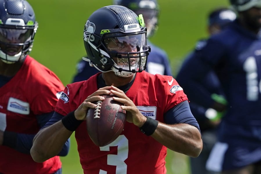 Seattle Seahawks quarterback Russell Wilson looks to pass during a practice drill at NFL football training camp, Wednesday, Aug. 12, 2020, in Renton, Wash. (AP Photo/Ted S.