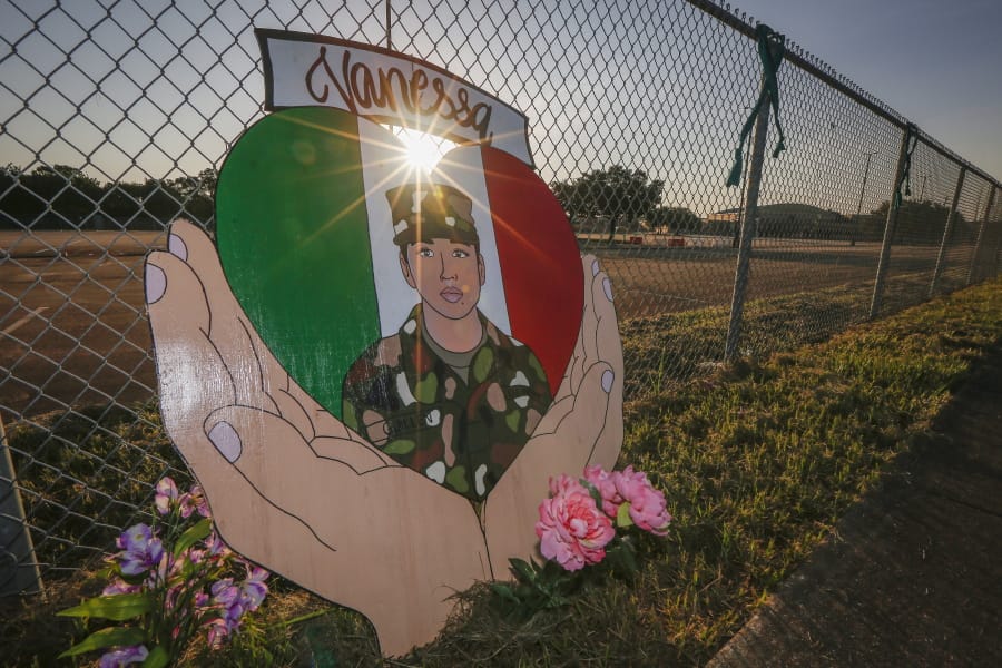 A small memorial for U.S. Army Specialist Vanessa Guillen is set up around Cesar Chavez High School Friday, Aug. 14, 2020, in Houston.  Investigators said Guillen was bludgeoned to death on base by a fellow soldier, who later killed himself.