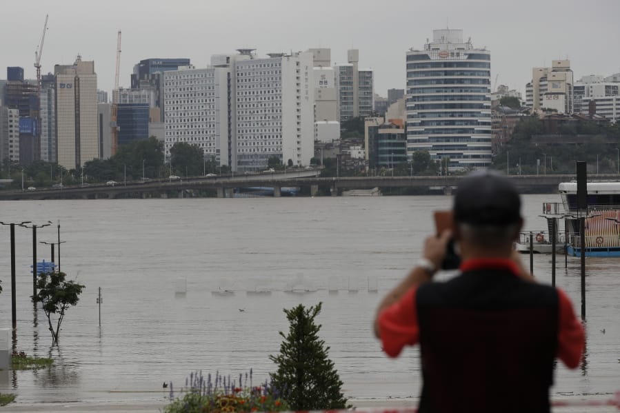 The display of South Korea&#039;s capital Seoul logo is almost submerged due to heavy rain at a park near the Han River in Seoul, South Korea, Thursday, Aug. 6, 2020. Torrential rains continuously pounded South Korea on Thursday, prompting authorities to close parts of highways and issue a rare flood alert near a key river bridge in Seoul.