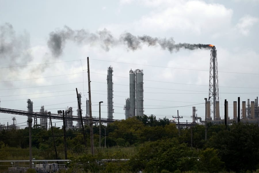 Winds blow the smoke from a refinery, Wednesday, Aug. 26, 2020, in Port Arthur, Texas.