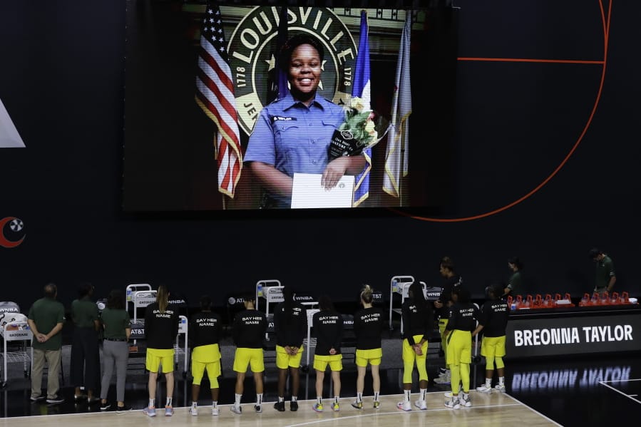 FILE - In this July 30, 2020, file photo members of the Seattle Storm stand in front of a photo of Breonna Taylor before a WNBA basketball game against the Washington Mystics in Bradenton, Fla. Taylor was killed in her home by police officers. Americans&#039; suggestions of suitable statues for President Donald Trump&#039;s planned National Garden of American Heroes are in, and they look considerably different from the predominantly white worthies that the administration has locked in for many of the pedestals. Lehigh County, Pennsylvania Commissioner Amy Zanelli, suggested George Floyd, Breonna Taylor, and other Black Americans whose killings by police sparked massive street protests.