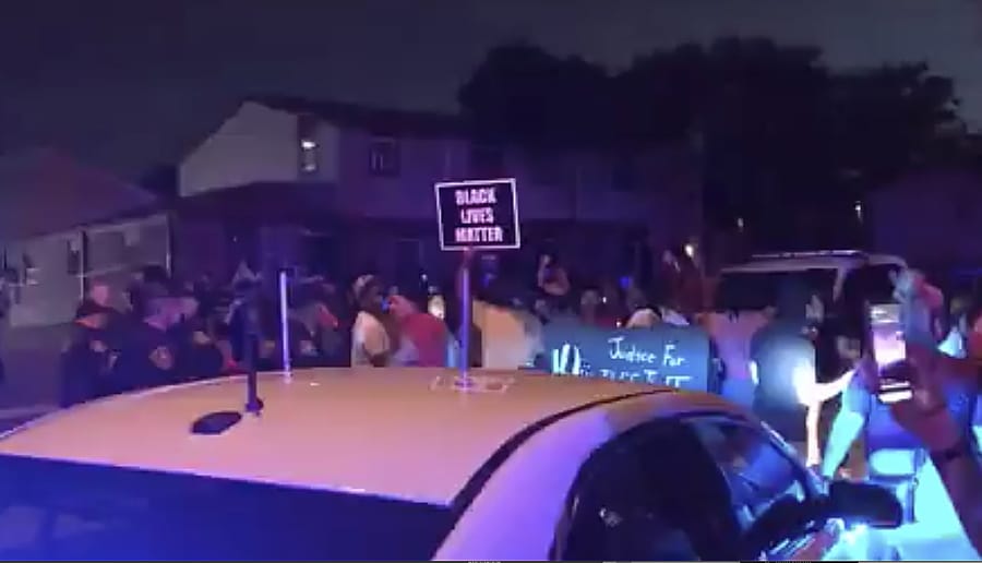 In this image made from video, protesters gather near the site of a police shooting, Sunday, Aug. 23 in Kenosha, Wisconsin. Officers deployed tear gas early Monday in an effort to disperse hundreds of people who took to the streets following a police shooting in Kenosha that also drew a harsh rebuke from the governor after a video posted on social media appeared to show officers shoot at a Black man&#039;s back seven times as he leaned into a vehicle.