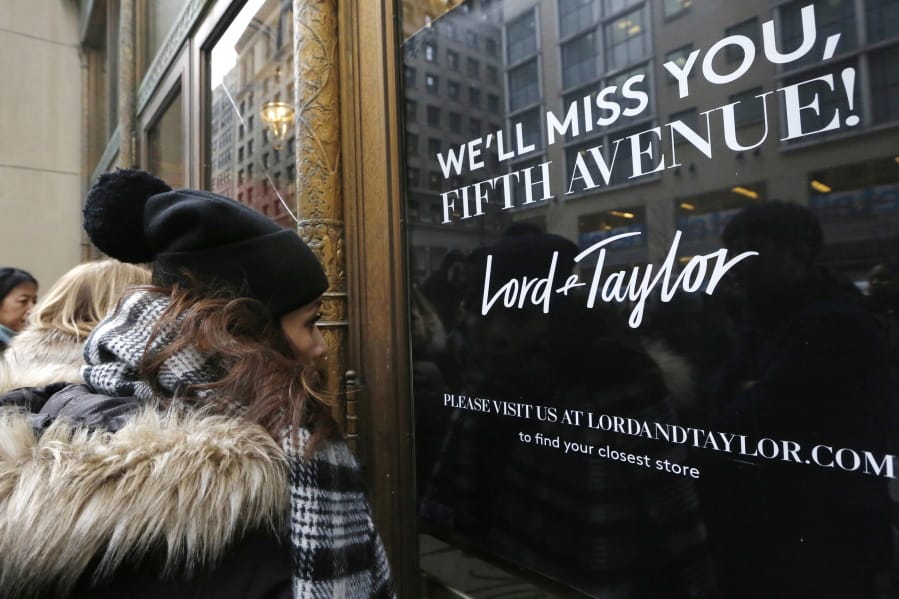 FILE - In this Jan. 2, 2019, file photo, women peer in the front door of Lord &amp; Taylor&#039;s flagship Fifth Avenue store which closed for good in New York. New York landmark retailer Lord &amp; Taylor has filed for bankruptcy, joining a growing list of retailers flummoxed by the pandemic.