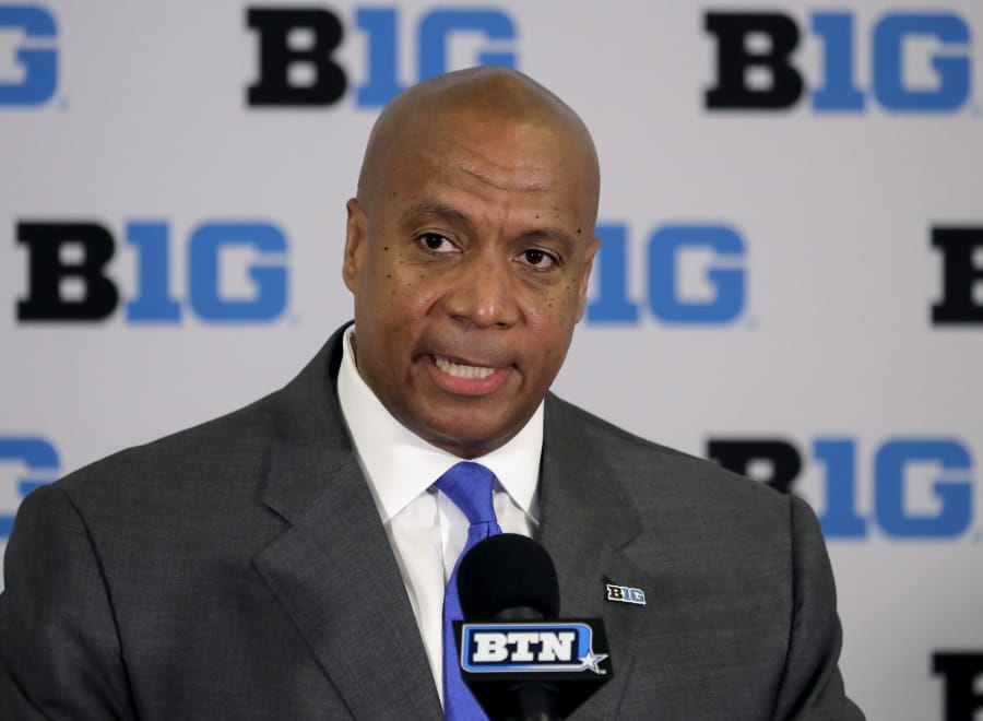 FILE - In this June 4, 2019, file photo,  Minnesota Vikings chief operating officer Kevin Warren talks to reporters after being named Big Ten Conference Commissioner during a news conference in Rosemont, Ill. After the Power Five conference commissioners met Sunday, Aug.
