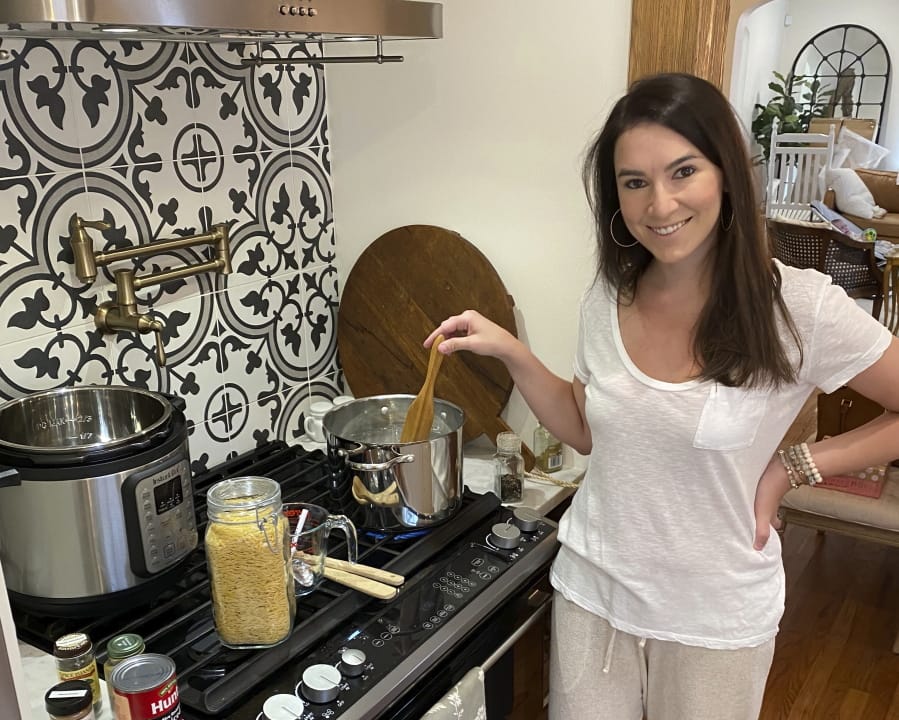This July 26, 2020 photo shows Erika Navarrete Nagle, a television producer in Denver, Colo., preparing a meal for her family in Denver. Before she began quarantining in late March, the 33-year-old had never cooked chicken. &quot;I was a mess in the kitchen,&#039;&#039; she says. &#039;&#039;I grew up in a Cuban family with a mother and sister who always cooked for me. You&#039;d think I picked up a thing or two, but I&#039;ve always been a workaholic and I never made time nor had the desire to cook.&quot; &quot;It took a global pandemic and mandatory quarantine for me to learn,&quot; she says.