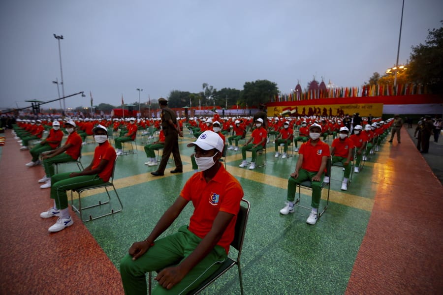 People wearing face masks and dressed in the colors of the national flag wait for the start of the Independence Day ceremony on the ramparts of the landmark Red fort monument in New Delhi, India, Saturday, Aug. 15, 2020. India&#039;s coronavirus death toll overtook Britain&#039;s to become the fourth-highest in the world with another single-day record increase in cases Friday.