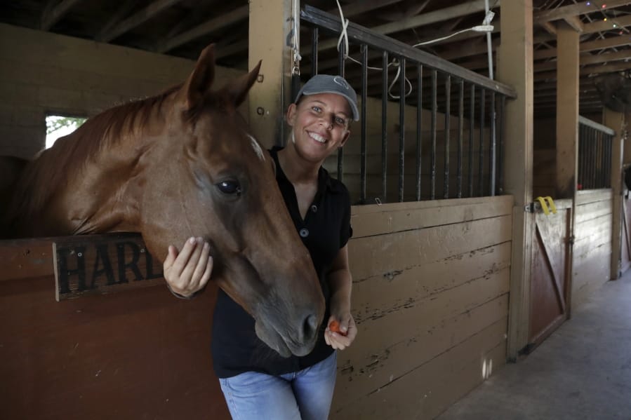 Timea Hunter poses for a photograph at the Family Horse Academy, where she is hoping to organize education for a group of children during the coronavirus pandemic, Friday, July 31, 2020, in Southwest Ranches, Fla. Confronting the likelihood of more distance learning, families across the country are turning to private tutors and &quot;learning pods&quot; to ensure their children receive some in-person instruction. The arrangements raise thorny questions about student safety, quality assurance, and inequality.