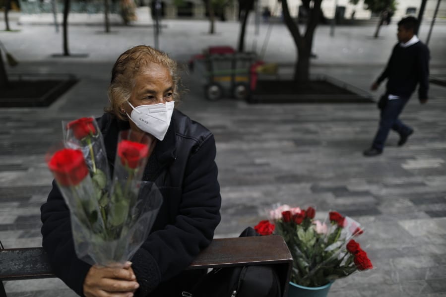 Wearing a mask to curb the spread of the new coronavirus, Martha Gonzalez Reyes, 76, sells roses outside Metro Hidalgo in central Mexico City, Monday, Aug. 10, 2020. After four months staying at home, Gonzalez returned to selling on August 1, but she says business hasn&#039;t fully rebounded.