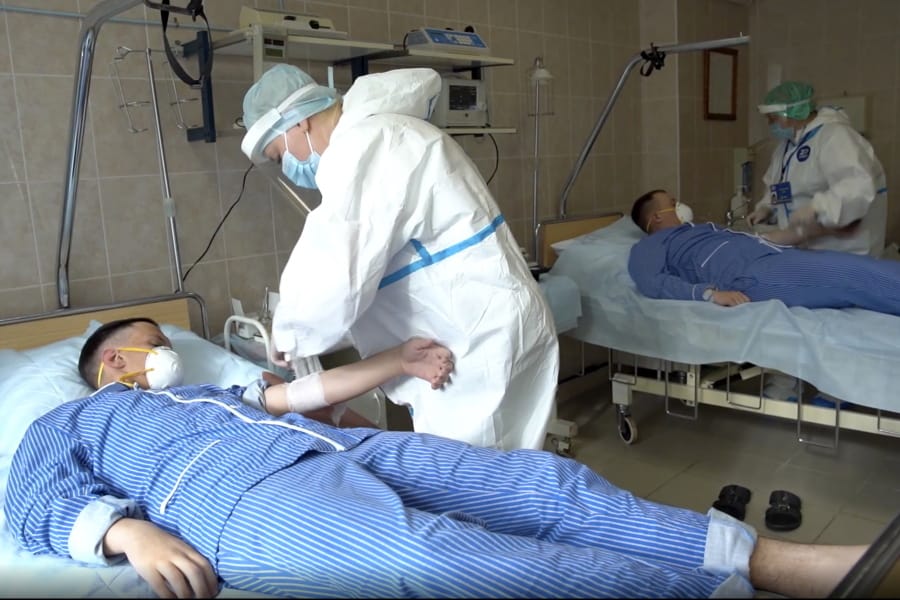 In this photo made from footage provided by the Russian Defense Ministry on Wednesday, July 15, 2020, medical workers in protective gear prepare to draw blood from volunteers participating in a trial of a coronavirus vaccine at the Budenko Main Military Hospital outside Moscow, Russia. Russia is boasting that it&#039;s about to be the first country to approve a COVID-19 vaccine, but scientists worldwide are sounding the alarm that the headlong rush could backfire.