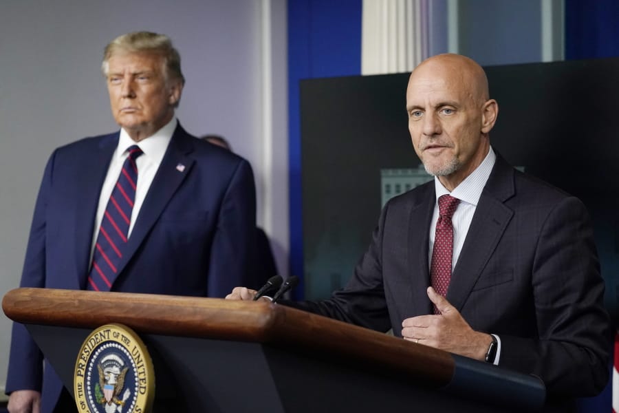 President Donald Trump listens as Dr. Stephen Hahn, commissioner of the U.S. Food and Drug Administration, speaks during a media briefing in the James Brady Briefing Room of the White House, Sunday, Aug.