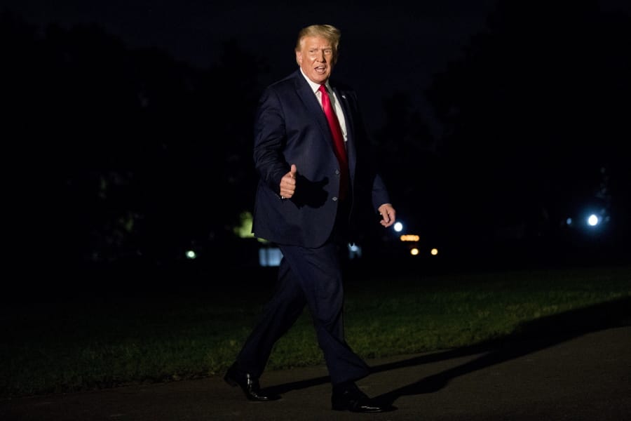 President Donald Trump gives a thumbs-up to members of the media as he walks across the South Lawn as he arrives at the White House in Washington, Sunday, Aug. 9, 2020, after returning from Morristown, N.J.