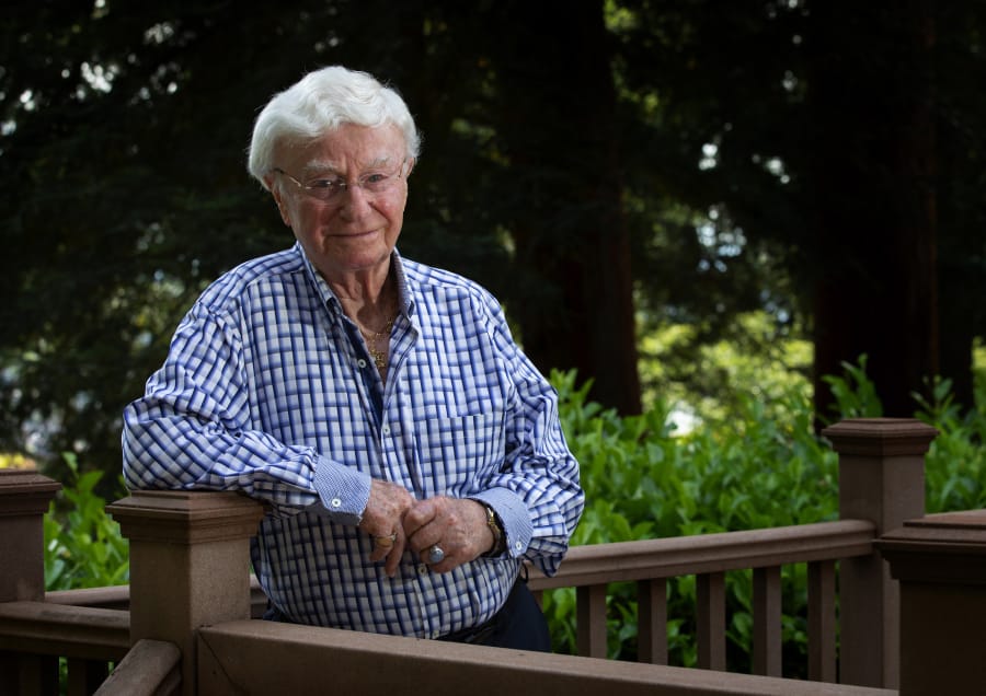 Henry Friedman stands on the deck behind his Mercer Island home Aug. 20. Friedman survived the Holocaust by hiding in an attic with his family. (Ellen M.