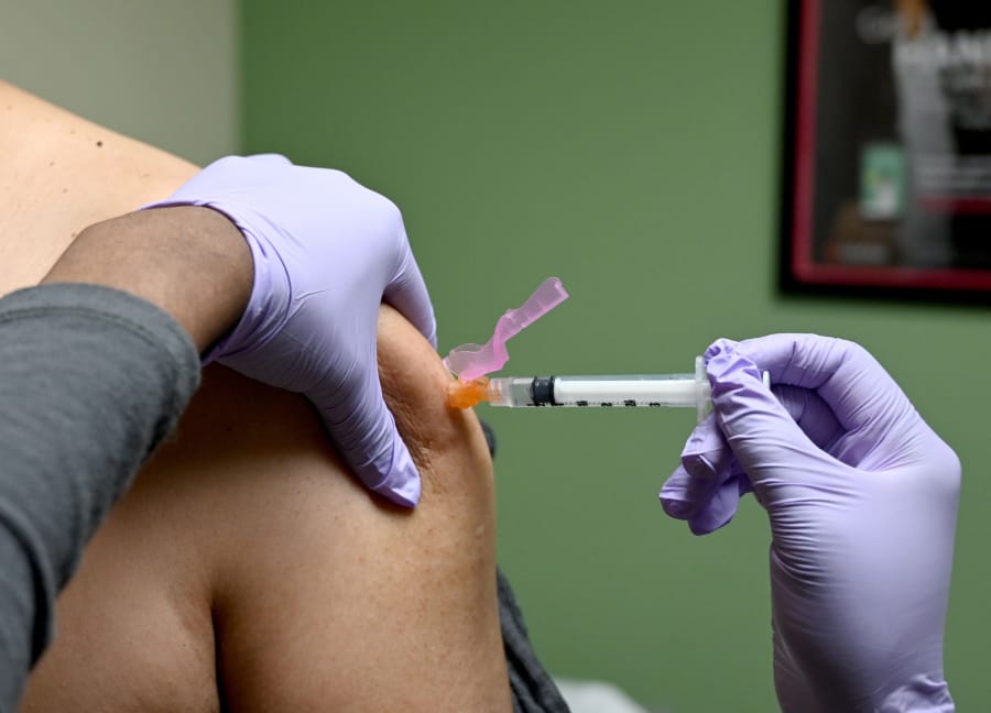In this file photo, a man gets a flu shot at a health facility in Washington, DC January 31, 2020. The U.S. Centers for Disease Control and Prevention plans a call with health-care providers to discuss flu vaccination, along with guidance for delivering vaccines during the pandemic.