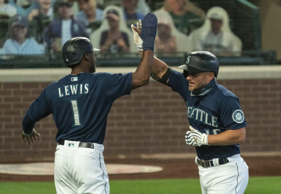 Seattle Mariners&#039; Kyle Seager, right, is congratulated by teammate Kyle Lewis after hitting a two-run home run off of Texas Rangers starting pitcher Kolby Allard during the first inning Monday in Seattle. The Mariners have won six straight games for the first time since July 2019.