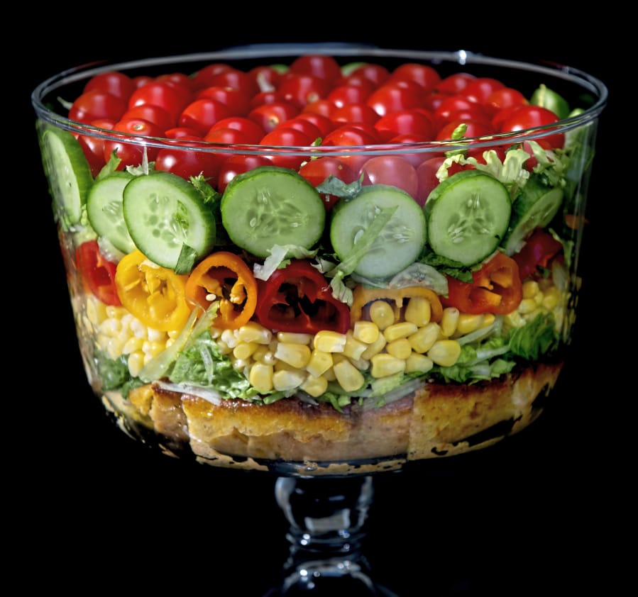 Built on a layer of savory cornbread, the summer trifle salad is made with shredded romaine lettuce, sweet corn, mini peppers, cucumbers and cherry tomatoes.