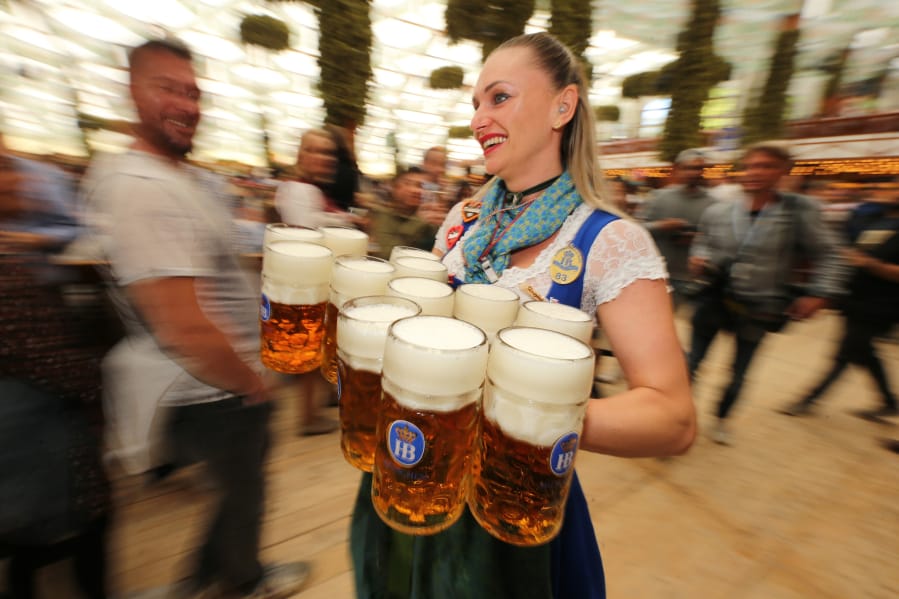 A waitress carries 1-liter mugs of beer during the opening weekend of the 2019 Oktoberfest in Munich, Germany. Here is a soundtrack to listen to if you are celebrating Oktoberfest at home this year.