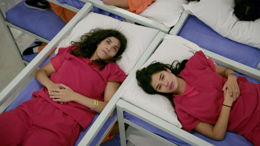Blanca Flores (Laura Gomez, left) and Maritza Ramos (Diane Guerrero) at an ICE detention center on &quot;Orange Is the New Black.&quot; (Netflix)