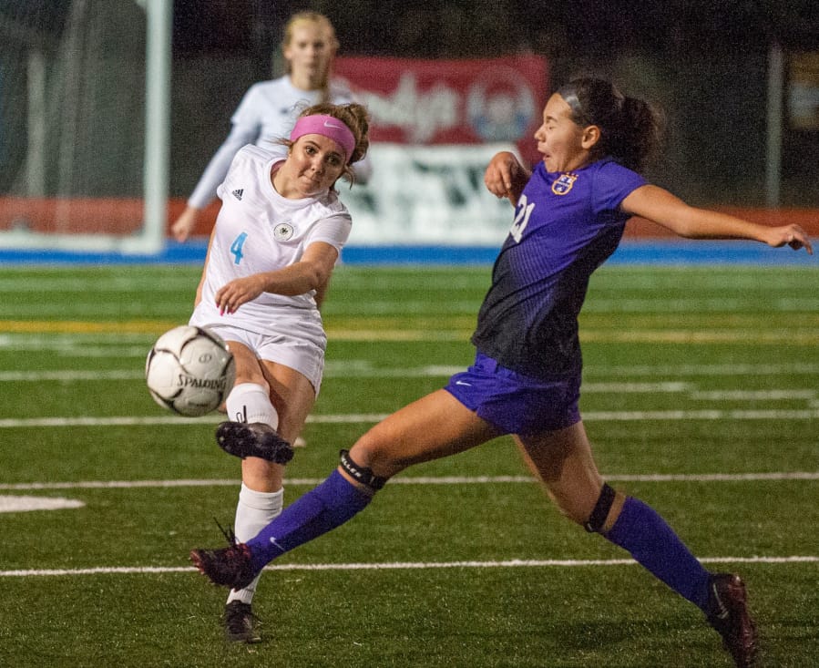 Hockinson&#039;s Kati Waggoner makes a pass as Columbia River&#039;s Andie Buckley tries to block it.