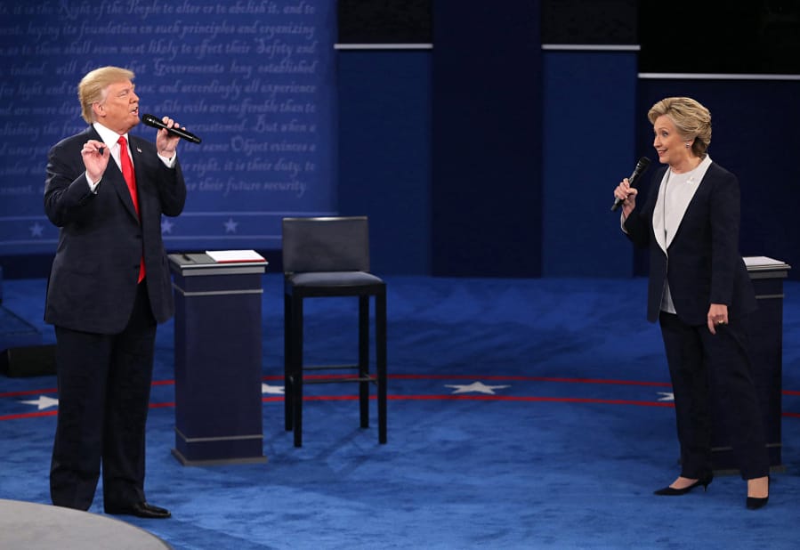 In this file image from the 2016 debates Donald Trump and and Hillary Clinton on stage during the second debate between the Republican and Democratic presidential candidates on October 9, 2016, at Washington University in St. Louis. (Christian Gooden/St.