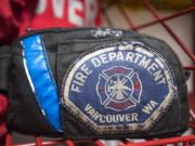 A Vancouver Fire Department patch is seen here in the gear room of Fire Station 2 (The Columbian files)