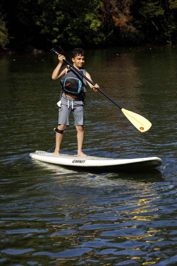 TIGARD, Ore.: Mariele Balasbas from Boys &amp; Girls Clubs of Southwest Washington and Teen Turf Club partnered with Chill, an organization that reaches youth through board sports, and Cascadia SUP &amp; SURF to engage four club members in paddleboarding at Cook Park in Tigard, Ore.