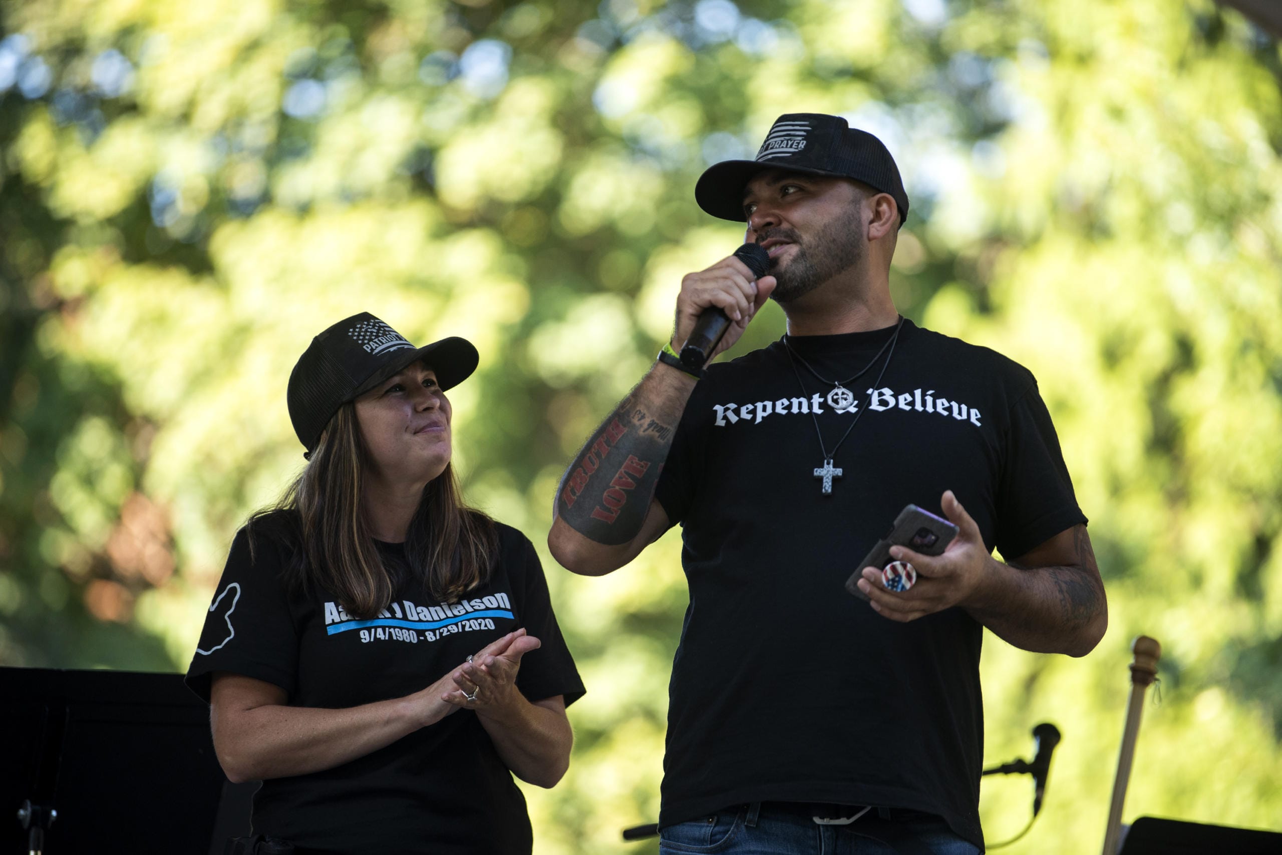 Michelle Dawson of Battle Ground, left, and Patriot Prayer leader Joey Gibson speak during the memorial to remember Aaron "Jay" Danielson who was fatally shot after a pro-Trump rally in Portland last month, at Esther Short Park in Vancouver on September 5, 2020.