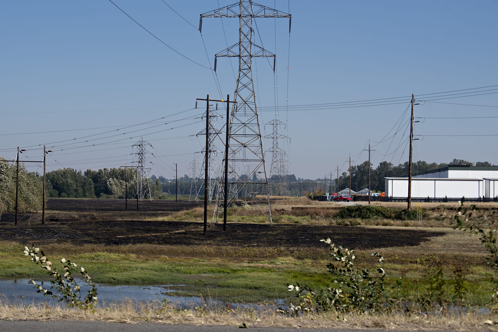 The charred remains of the Fruit Valley fire are seen from Lower River Road on Wednesday morning, Sept. 9, 2020.