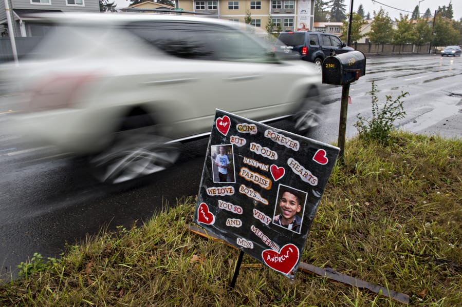 Motorists drive past a small memorial for two boys who died in January, as seen near the intersection Northeast 23rd Street and Northeast 112th Avenue. The kids -- Taylor Crepeau, 14, and Andrew Friedt, 17 -- were hit by a car while trying to cross Northeast 112th Avenue.