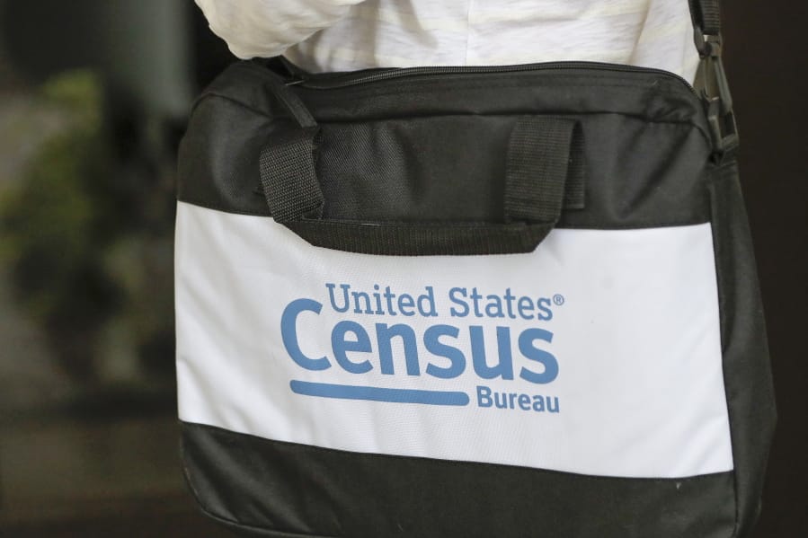 A briefcase of a census taker is seen as she knocks on the door of a residence Tuesday, Aug. 11, 2020, in Winter Park, Fla. A half-million census takers head out en mass this week to knock on the doors of households that haven&#039;t yet responded to the 2020 census.