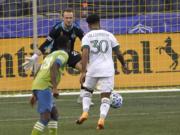 Portland Timbers midfielder Eryk Williamson (30) sets up to kick a goal against Seattle Sounders goalkeeper Stefan Frei, center, during the first half of an MLS soccer match, Sunday, Sept. 6, 2020, in Seattle. (AP Photo/Ted S.