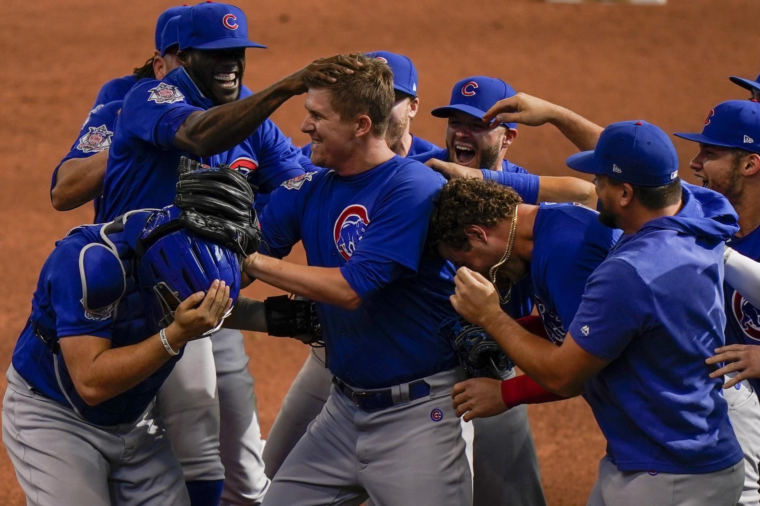 Chicago Cubs starting pitcher Alec Mills is swarmed by teammates after throwing a no hitter at a baseball game against the Milwaukee Brewers Sunday, Sept. 13, 2020, in Milwaukee. The Cubs won 12-0.