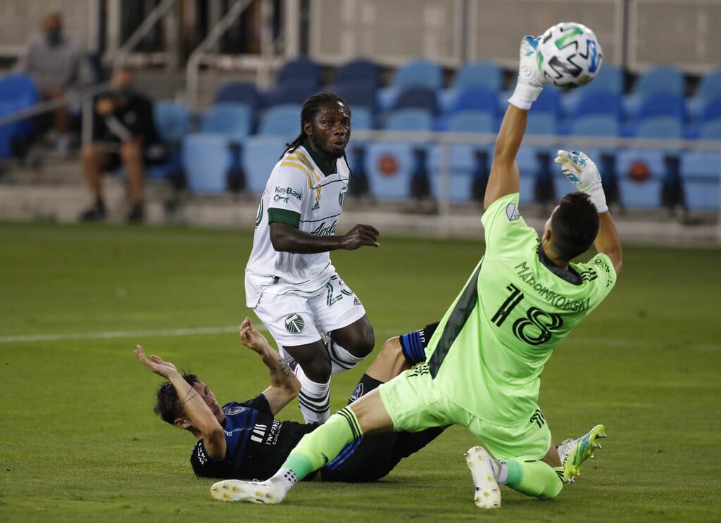 Portland Timbers forward Yimmi Chara (23), center, scores a goal against San Jose Earthquakes defender Paul Marie (33) and San Jose Earthquakes goalkeeper JT Marcinkowski (18), right, during the first half of an MLS soccer match Wednesday, Sept. 16, 2020, in San Jose, Calif.