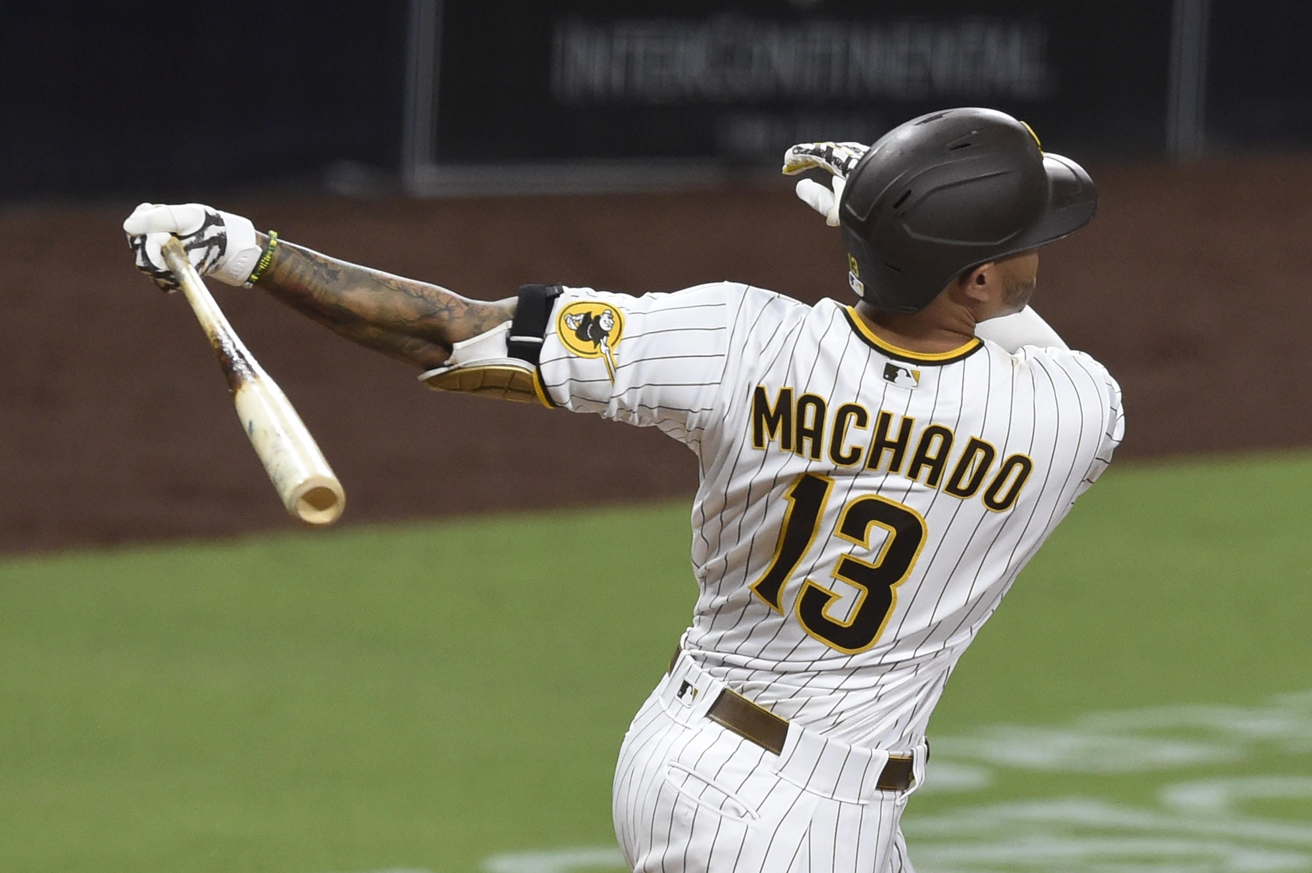 San Diego Padres' Manny Machado hits a solo home run during the ninth inning of the team's baseball game against the Seattle Mariners on Friday, Sept. 18, 2020, in San Diego.