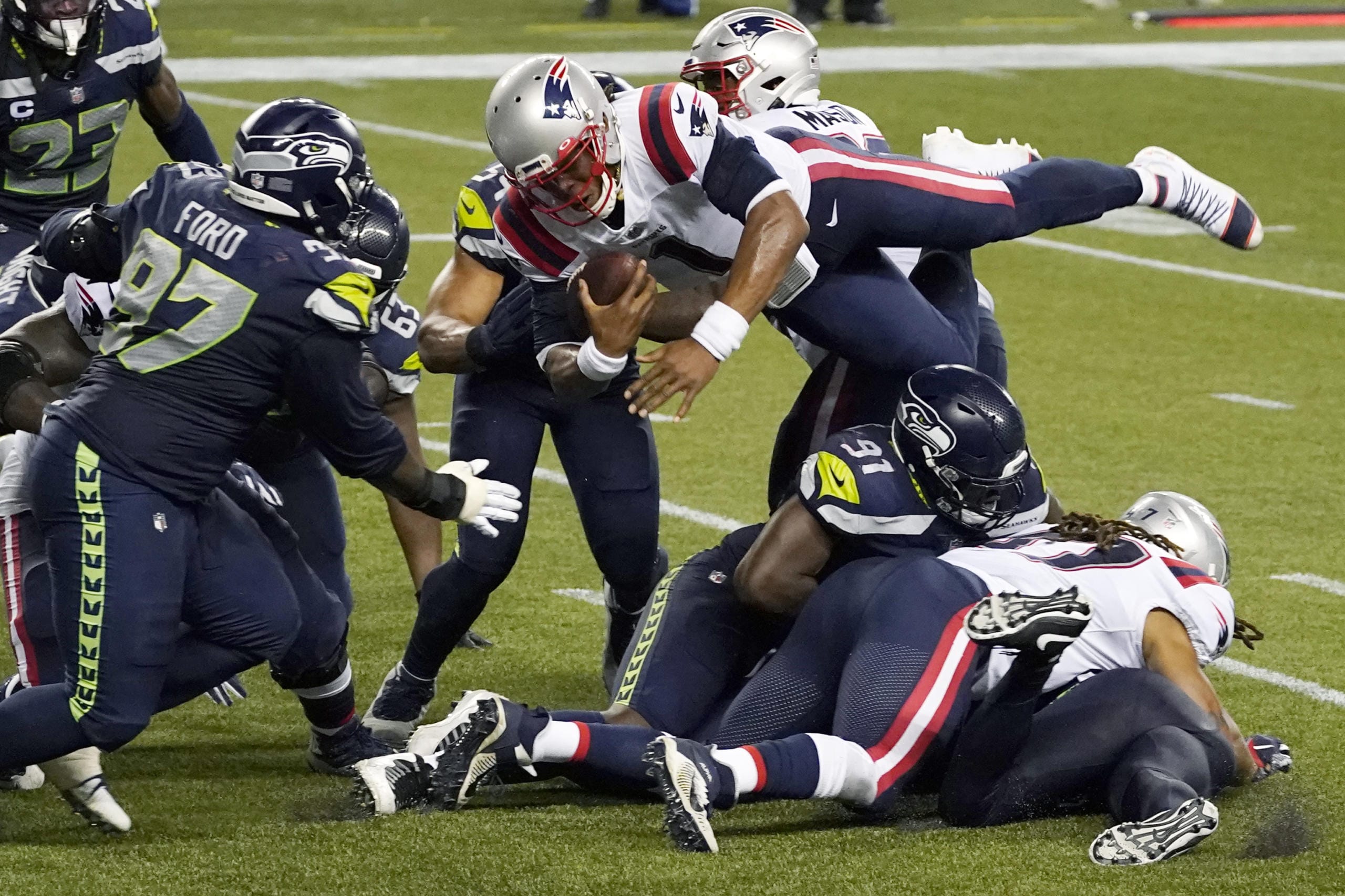 New England Patriots quarterback Cam Newton dives with the ball but is stopped near the goal line as the clock expires in the fourth quarter of an NFL football game against the Seattle Seahawks, Sunday, Sept. 20, 2020, in Seattle. The Seahawks won 35-30.