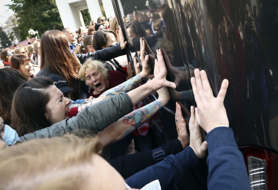 Women block a police bus during an opposition rally to protest the official presidential election results in Minsk, Belarus, Saturday, Sept. 12, 2020.