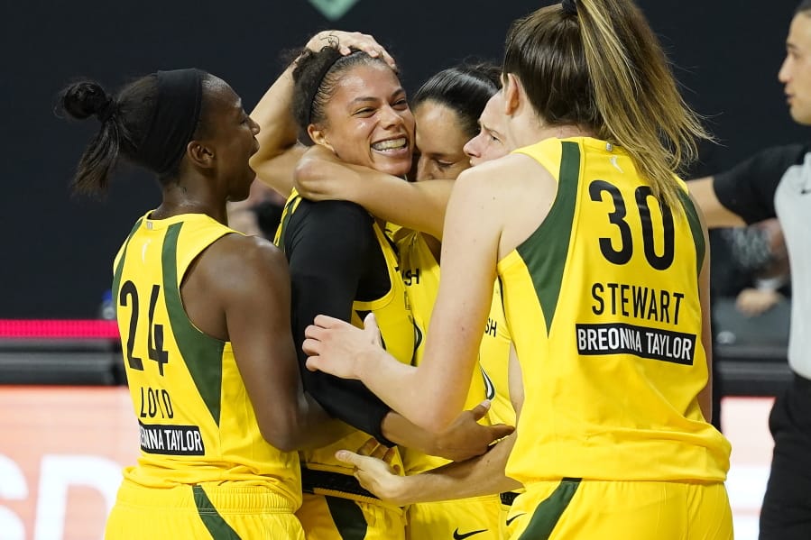 Seattle Storm forward Alysha Clark celebrates her game-winning shot with guard Jewell Loyd (24) and forward Breanna Stewart (30) during the second half of Game 1 of a WNBA basketball semifinal round playoff series against the Minnesota Lynx Tuesday, Sept. 22, 2020, in Bradenton, Fla.