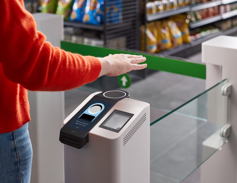 This undated photo provided by Amazon shows the Amazon One device at an Amazon Go store in Seattle. Amazon has introduced the new palm recognition technology in a pair of Seattle stores and sees broader uses in places like stadiums and offices.  Customers at the stores near Amazon&#039;s campus in Washington can flash a palm for entry and to buy goods.